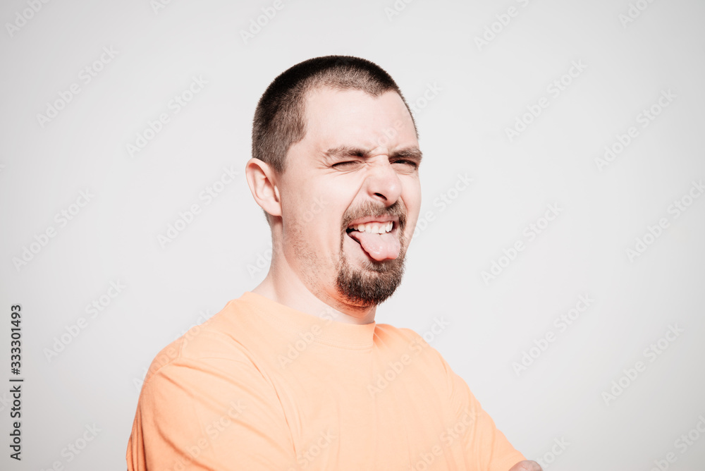 Fototapeta premium Man shows tongue