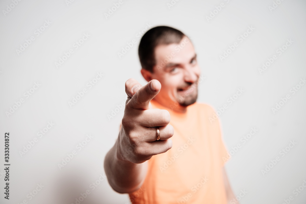 Young man showing his index finger towards the camera Young man showing his index finger towards the camera
