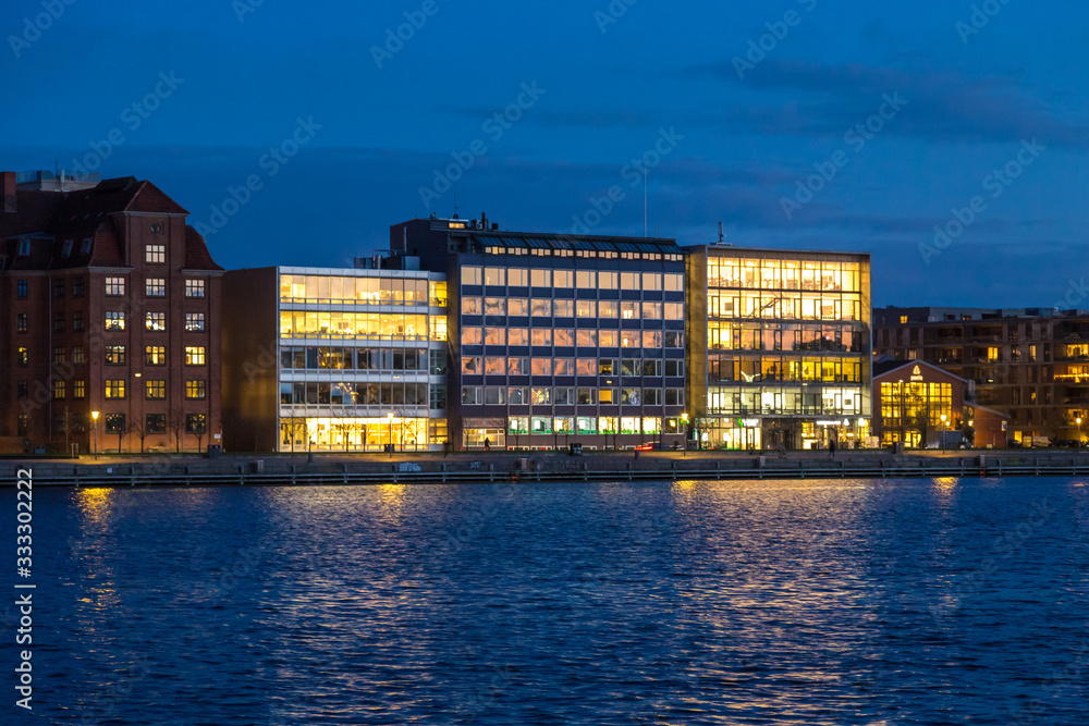 old and modern buildings on Copenhagen embankment, evening view