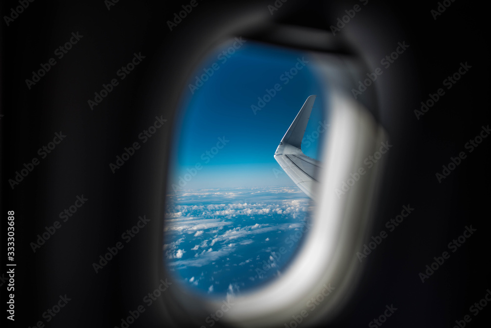 Window seat view on an airplane with clouds Window seat view on an airplane with clouds