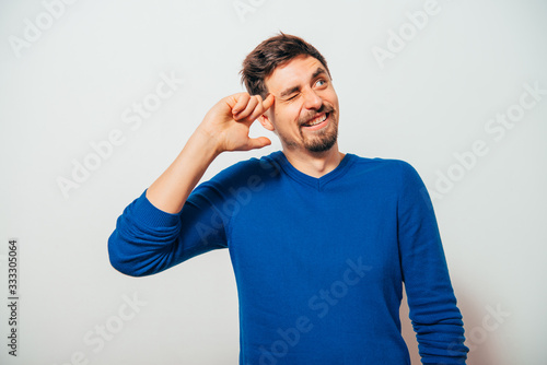 finger to his temple. A man shooting with a finger on his head. Desperate stressed young businessman with finger to his temple like a gun