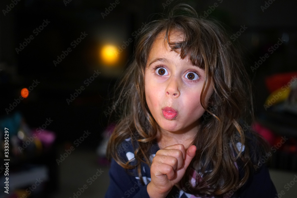 little girl with big eyes make funny faces, with copy space little girl with big eyes make funny faces, with copy space