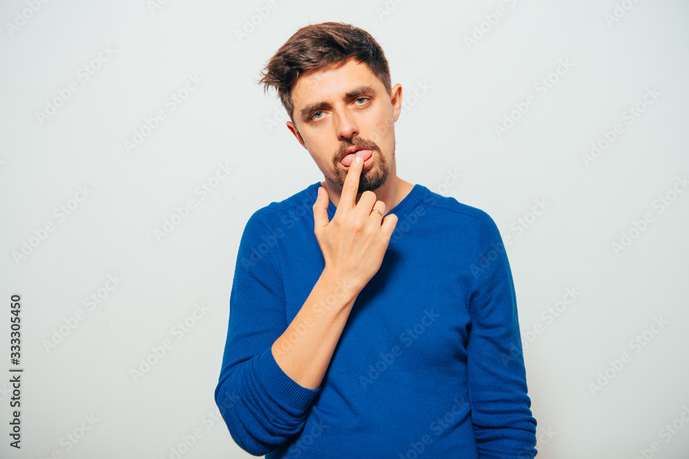 man shows his finger on the tongue