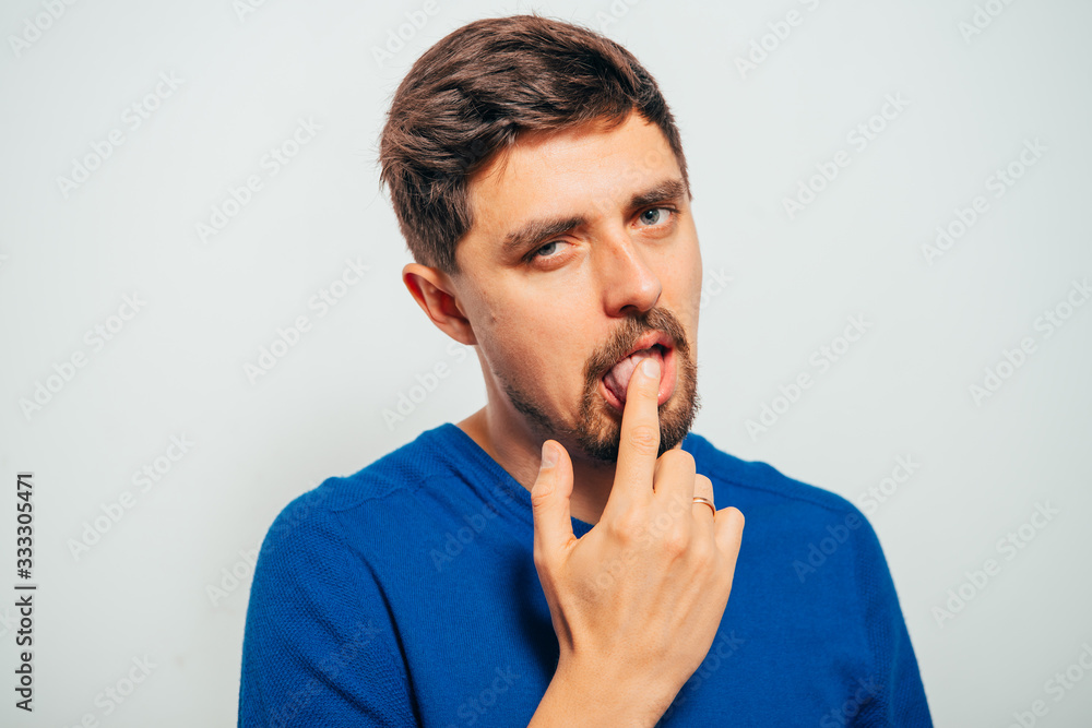 man shows his finger on the tongue man shows his finger on the tongue