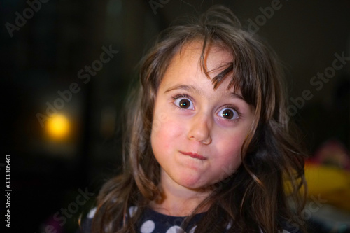 Wallpaper Mural little girl with big eyes make funny faces, with copy space Torontodigital.ca