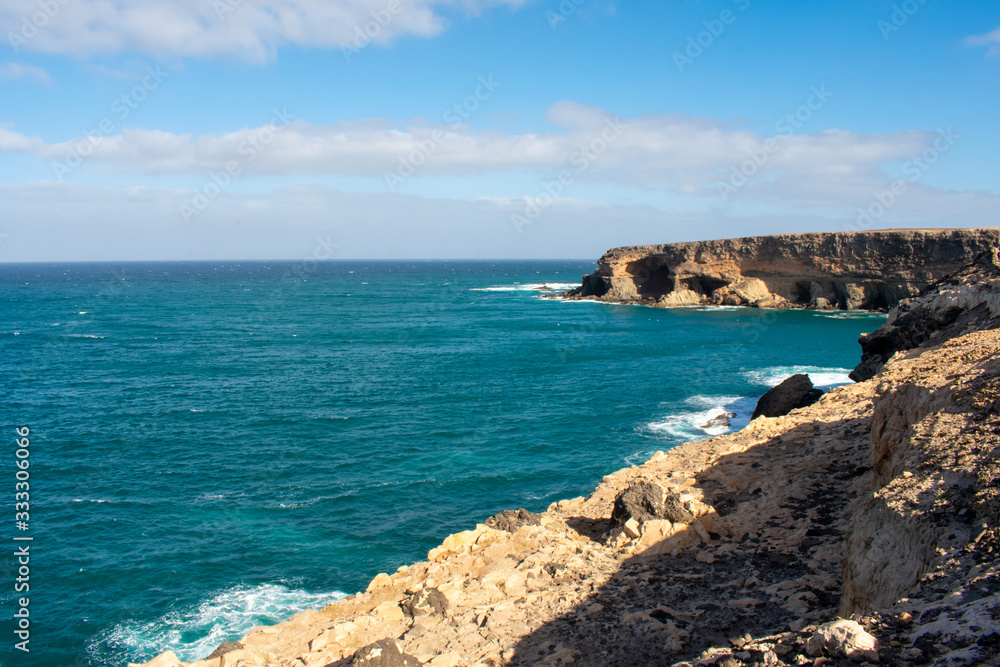 Aerial view of Black Sandy Beach, Coast of Atlantic Ocean and Cliffs in Ajuy, Furteventura, Canary Islands, Spain Aerial view of Black Sandy Beach, Coast of Atlantic Ocean and Cliffs in Ajuy, Furteventura, Canary Islands, Spain