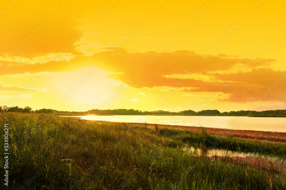 Picturesque view of beautiful lake at sunset