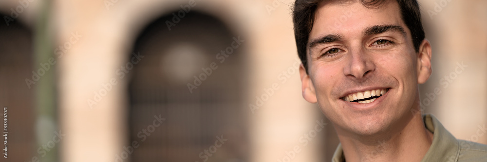 Portrait of young smiling man isolated on outside outdoor background Portrait of young smiling man isolated on outside outdoor background