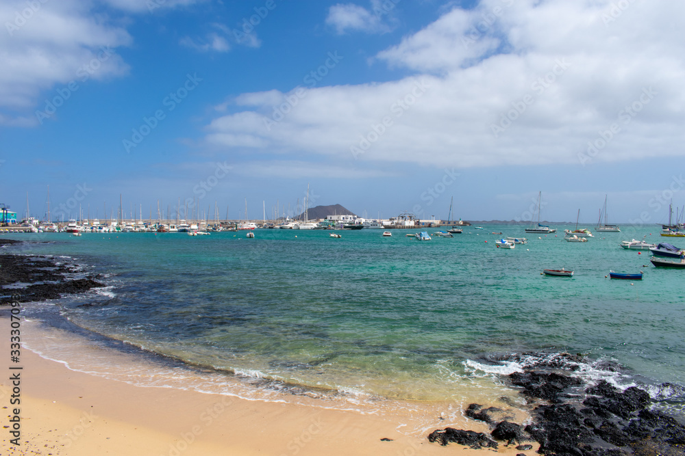 Corralejo, Fuerteventura, Canary Islands, Spain: Boats and Yachts in Corralejo Port, calm ocean water 