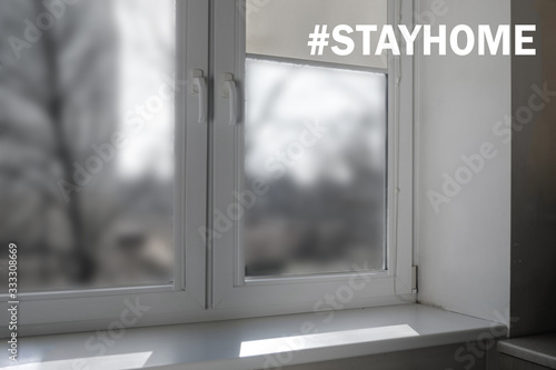 Empty white window with a white window sill and shutters. the inscription stay home for quarantine COVID-19.. 