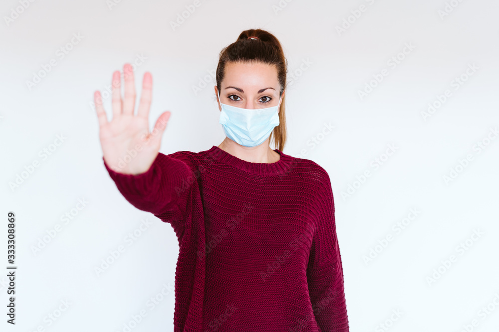 caucasian woman indoors wearing protective mask. Making a stop sign with hand. corona virus concept covid-19 caucasian woman indoors wearing protective mask. Making a stop sign with hand. corona virus concept covid-19