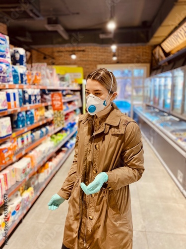 girl in a protective mask and gloves against coronavirus in a supermarket. beautiful young woman. grocery store. Russian girl. Covid-2019.