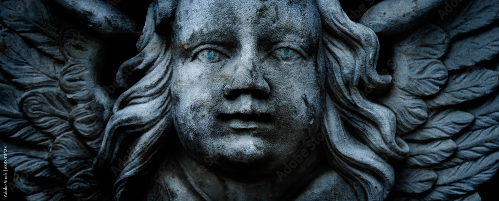 Close up antique stone statue of angel. Retro filter and vintage style. Close up antique stone statue of angel. Retro filter and vintage style.