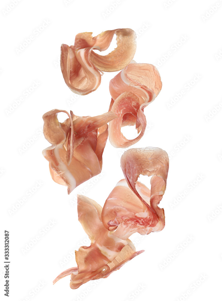 Fototapeta premium Set of flying cut delicious prosciutto on white background
