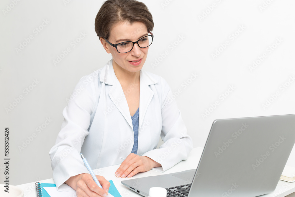 Portrait of a happy female doctor consulting video call in online chat on laptop. Portrait of a happy female doctor consulting video call in online chat on laptop.