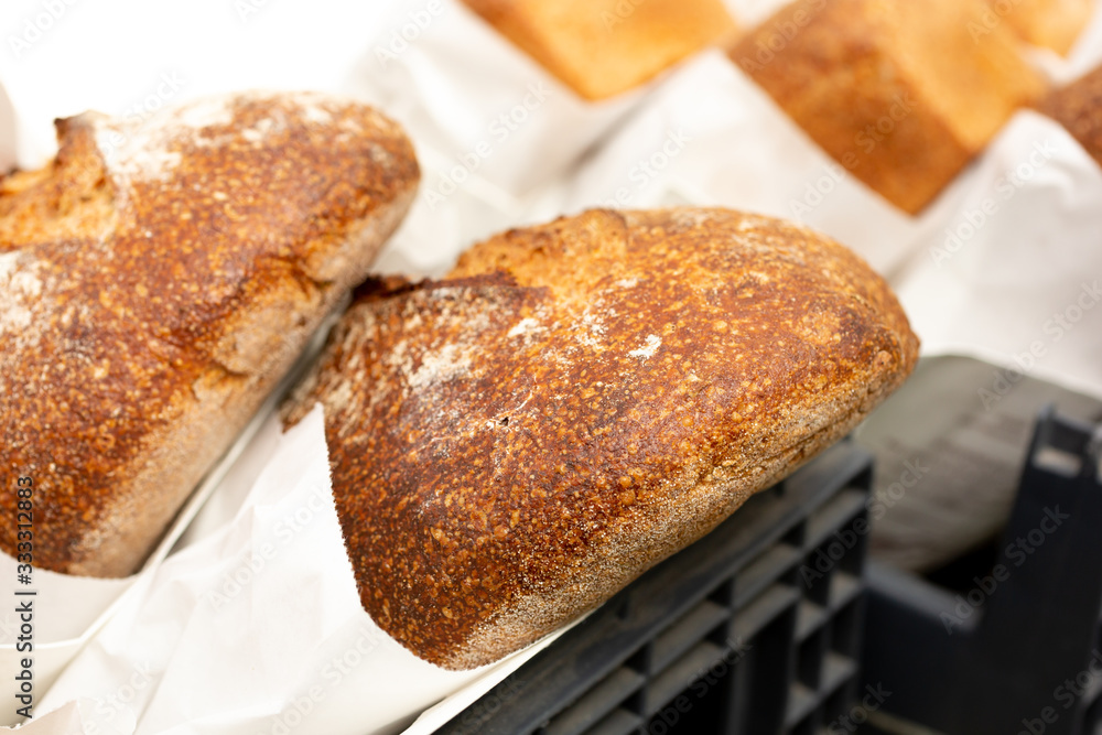 A closeup view of several rustic loaves of bread, seen at a local bakery.