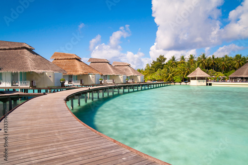 A view at the beach and waterhuts at tropical island, Maldives