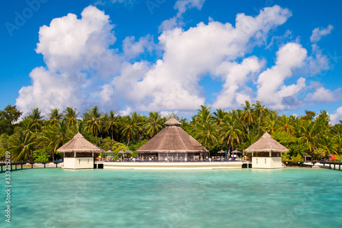 A view at the beach and waterhuts at tropical island, Maldives