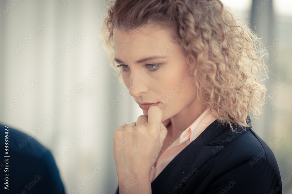 Confident business woman with curly blonde hair is standing in the meeting room , Concept working women and business Confident business woman with curly blonde hair is standing in the meeting room , Concept working women and business