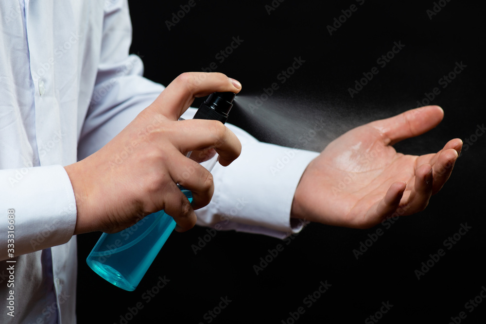Hand applying alcohol or anti bacteria spray to prevent spread germs, bacteria and virus. Personal hygiene. Covid-19 Coronavirus disinfection concept Hand applying alcohol or anti bacteria spray to prevent spread germs, bacteria and virus. Personal hygiene. Covid-19 Coronavirus disinfection concept