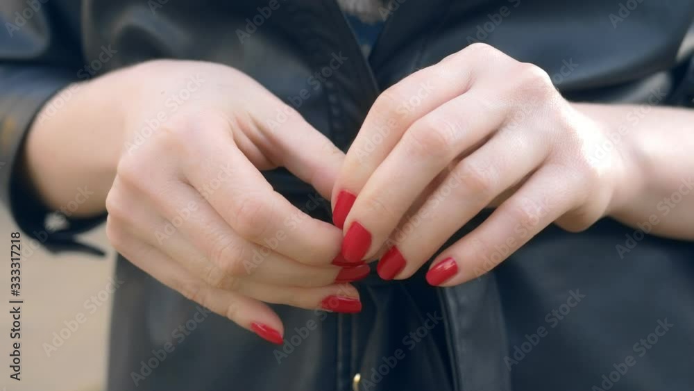 closeup hands. woman takes off a wedding ring while standing on the street closeup hands. woman takes off a wedding ring while standing on the street