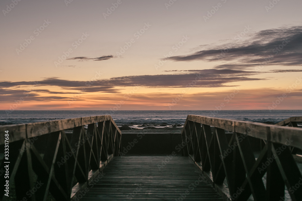 sunset at sea wooden fence