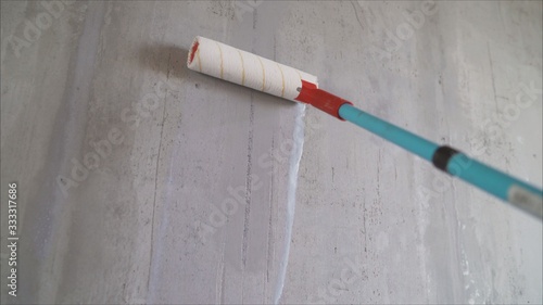 Paint the bare wall with a paint roller. Hand painted by roller. Primer Wall Roller