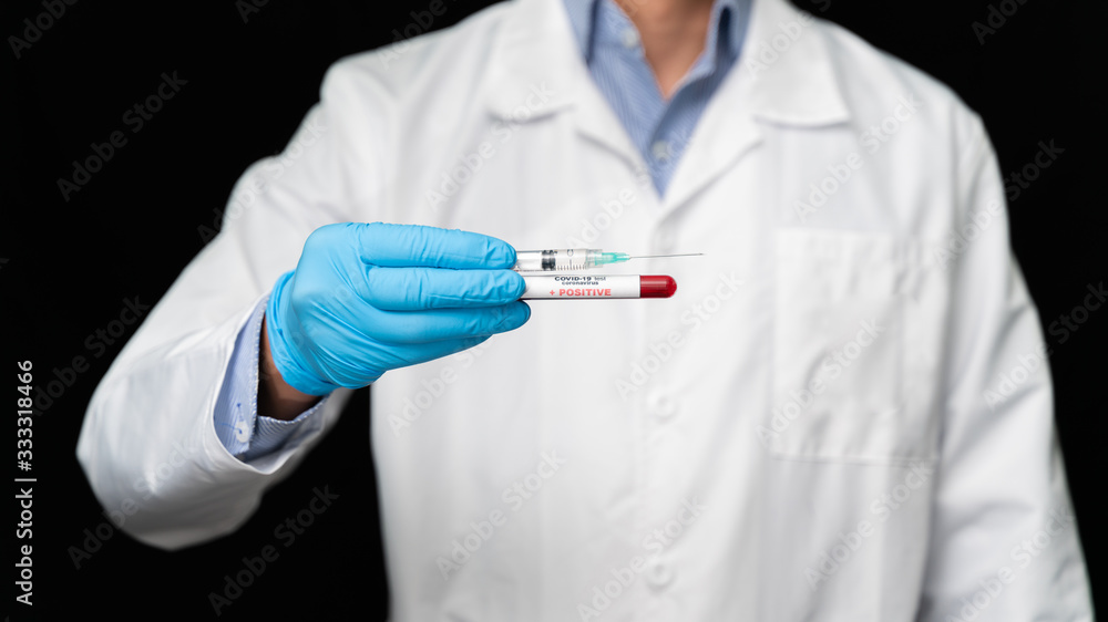 Doctor holds COVID 19 Coronavirus vaccine in his hand, infected blood sample in the sample tube, Vaccine and syringe injection It use for prevention, immunization and treatment from COVID-19 Doctor holds COVID 19 Coronavirus vaccine in his hand, infected blood sample in the sample tube, Vaccine and syringe injection It use for prevention, immunization and treatment from COVID-19