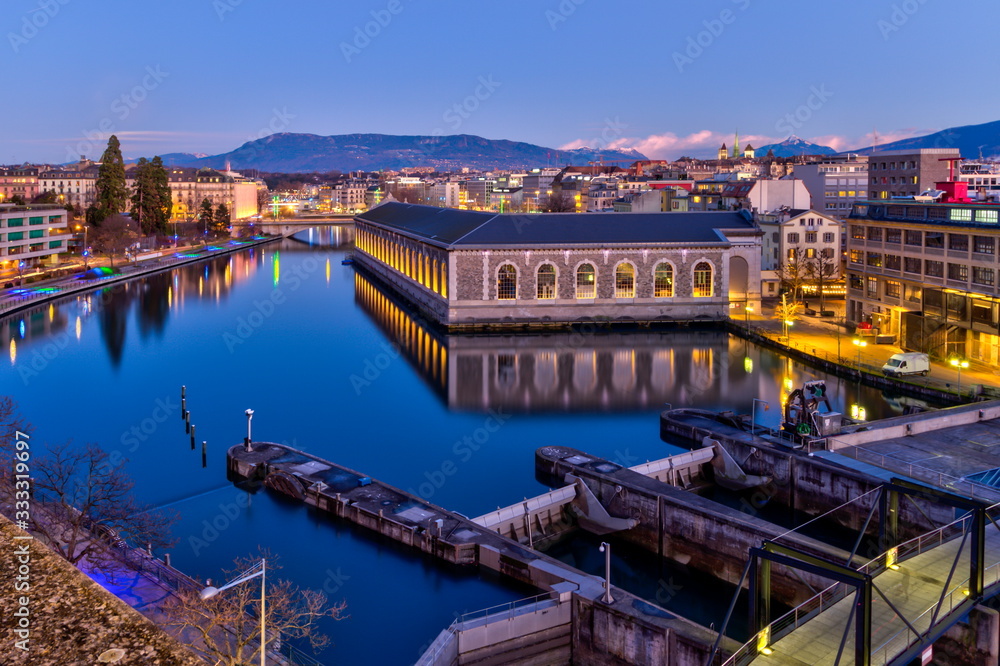 BFM, cathedral Saint-Pierre green tower and Rhone river by night with full moon, Geneva, Switzerland, HDR