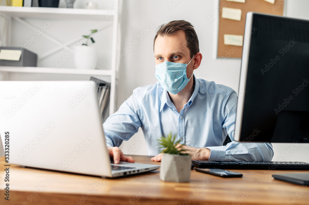Man in a medical mask at the office Man in a medical mask at the office