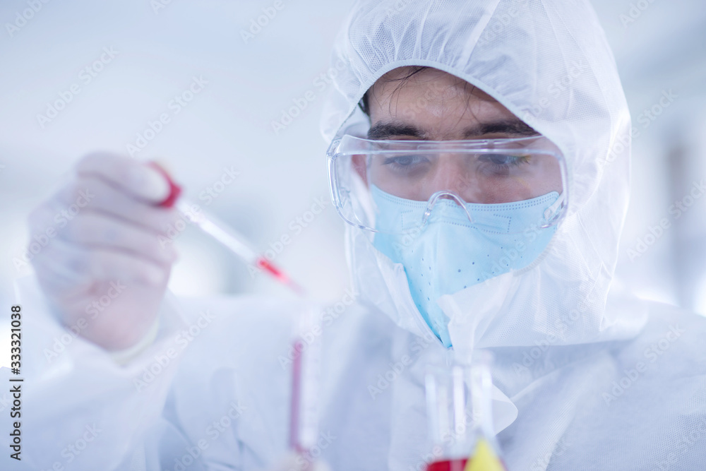 Male scientists is experimenting with chemicals in the laboratory. Concept, The scientists wear white protective clothing is experimenting with drug anti- Coronavirus, Covid19 Male scientists is experimenting with chemicals in the laboratory. Concept, The scientists wear white protective clothing is experimenting with drug anti- Coronavirus, Covid19