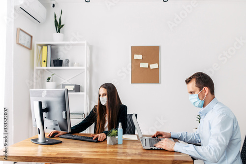 Office workers in medical masks during pandemia