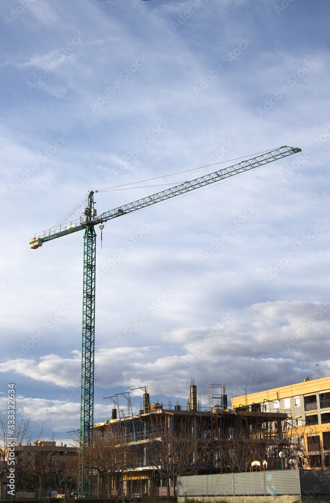 Crane of a construction site that is constructing a building
