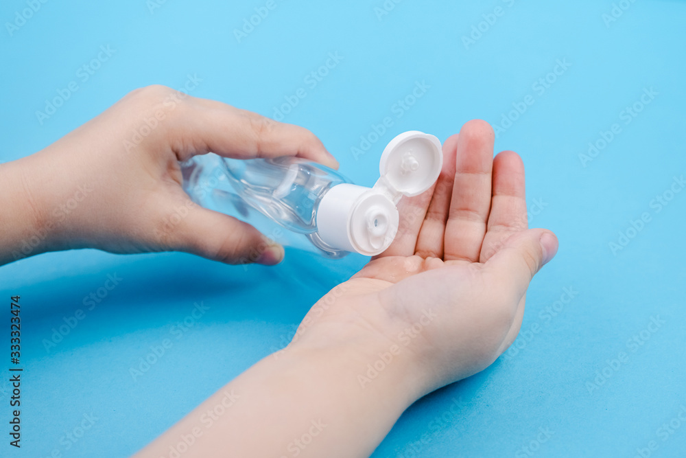 Hand cleaning gel. Pouring sanitising hand gel onto the child's hand Hand cleaning gel. Pouring sanitising hand gel onto the child's hand