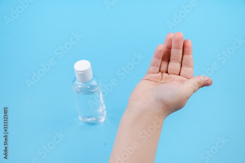 Hand cleaning gel. Pouring sanitising hand gel onto the child's hand