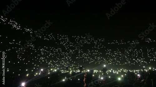 Phone lights at concert in a stadium