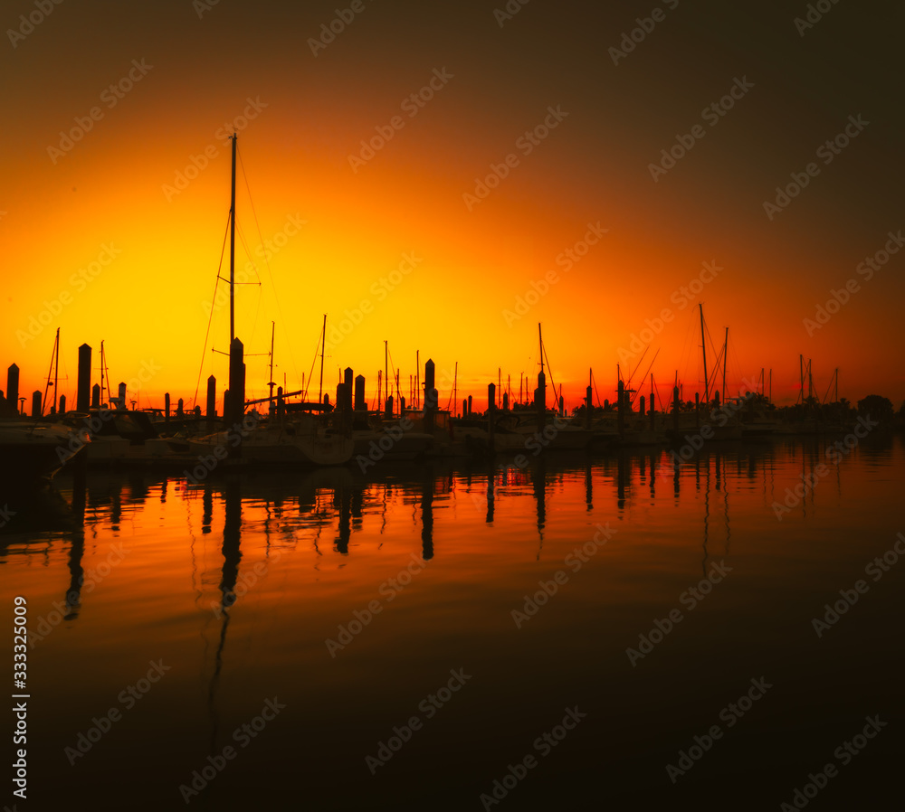 sunset sun aquatic sea boat sunrise nature sailing boat landscape port florida silhouette river dusk ocean orange summer