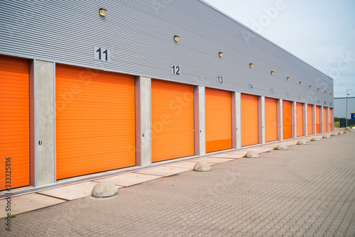 small business units with orange roller doors