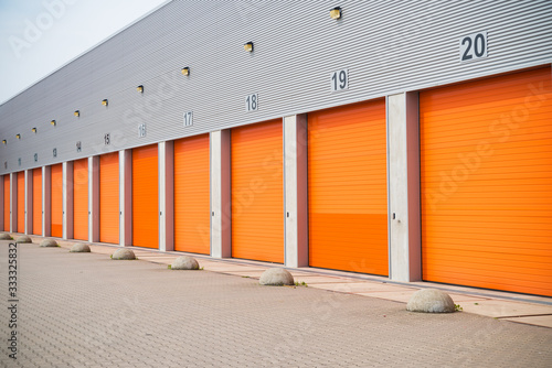 small business units with orange roller doors