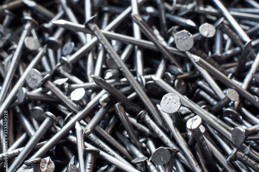 Macro photo of metal nails top view. Industrial building background made of steel nails close-up. Macro photo of metal nails top view. Industrial building background made of steel nails close-up.