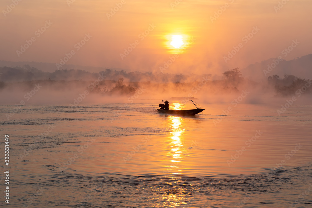 Silhouette Fisherman Fishing Nets on the boat,Fishing and outdoor activities concept. Silhouette Fisherman Fishing Nets on the boat,Fishing and outdoor activities concept.