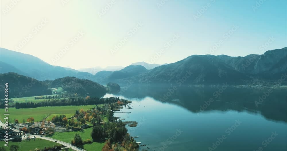 Green valley village on green hills at the bottom of mountains, near lake. Green valley village on green hills at the bottom of mountains, near lake.
