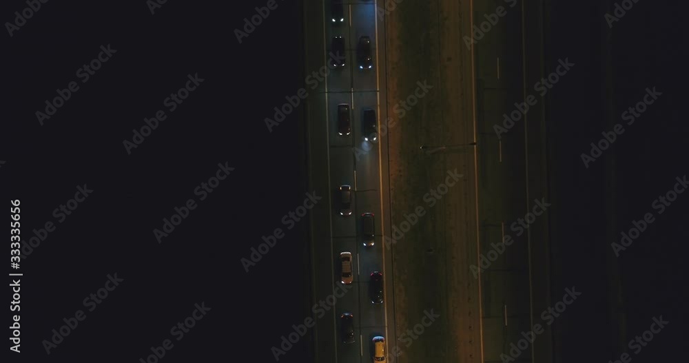Cars are slowly riding on highway at night. Top aerial view. Traffic jam. Cars are slowly riding on highway at night. Top aerial view. Traffic jam.