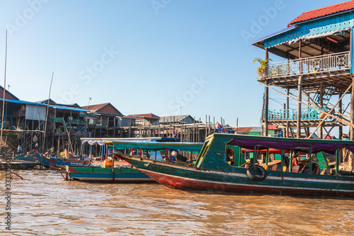 Kampong Phluk Floating Village on the Tonle Sap lake near Siem Reap, Cambodia during sunset. The Stilt houses of the floating town during low tide. Exotic places at South East Asia