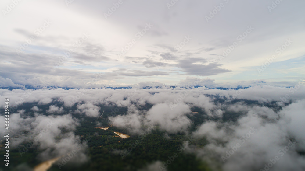 Over the clouds at the Malaysian landscape.  Aerial view over the rainforest near the Gua Charas Rock, Pahang, Malaysia, not far from the east coast of Malaysia and the town of Kuantan. 