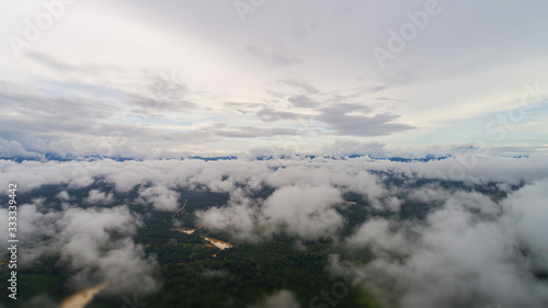 Over the clouds at the Malaysian landscape. Aerial view over the rainforest near the Gua Charas Rock, Pahang, Malaysia, not far from the east coast of Malaysia and the town of Kuantan. 