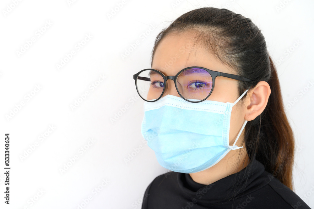 Shot of young Asian woman worring and wearing mask for protect bad air pollution or virus. Air pollution has been associated with diseases of the heart and lungs, cancers and other health problems. Shot of young Asian woman worring and wearing mask for protect bad air pollution or virus. Air pollution has been associated with diseases of the heart and lungs, cancers and other health problems.