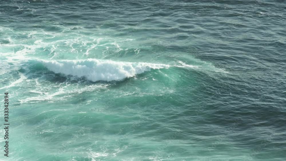 View from above, stunning aerial view of waves that crash on a beach in Bali. Bali is part of the Coral Triangle, the area with the highest biodiversity of marine species especially fish and turtles. View from above, stunning aerial view of waves that crash on a beach in Bali. Bali is part of the Coral Triangle, the area with the highest biodiversity of marine species especially fish and turtles.