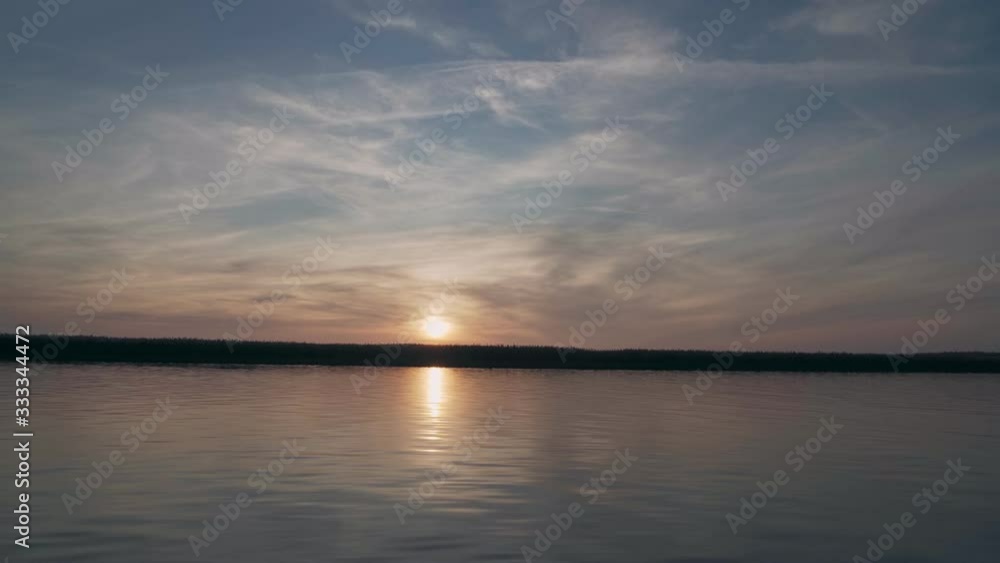 Amazing sunset over the river, view from the boat in motion Amazing sunset over the river, view from the boat in motion