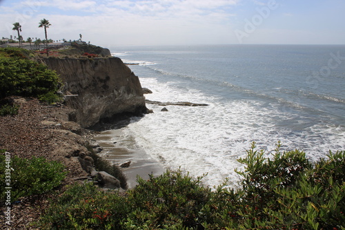 beach cove with waves and rocsk photo